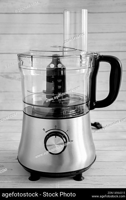 Multifunctional food processor, chop, chop, mix vegetables, fruits and other food. Facade. Black and white image