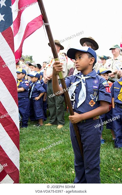 Cubscout display US Flag at solemn 2014 Memorial Day Event, Los Angeles National Cemetery, California, USA