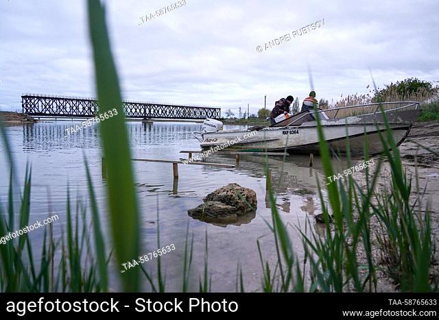 RUSSIA, GENICHESK - APRIL 30, 2023: Fishermen leave the Henichesk Seaport to go fishing in the Sea of Azov on the closing day of the season for catching turbot