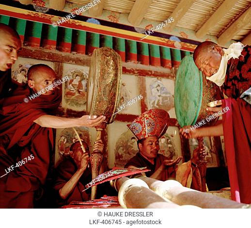 Monks with drums and wind instruments recieving blessed food during the Hemis Gonpa Festival at convent Hemis, southeast of Leh, Ladakh, Jammu and Kashmir