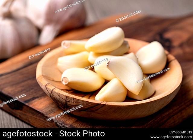 Garlic Cloves and Bulb in vintage wooden bowl