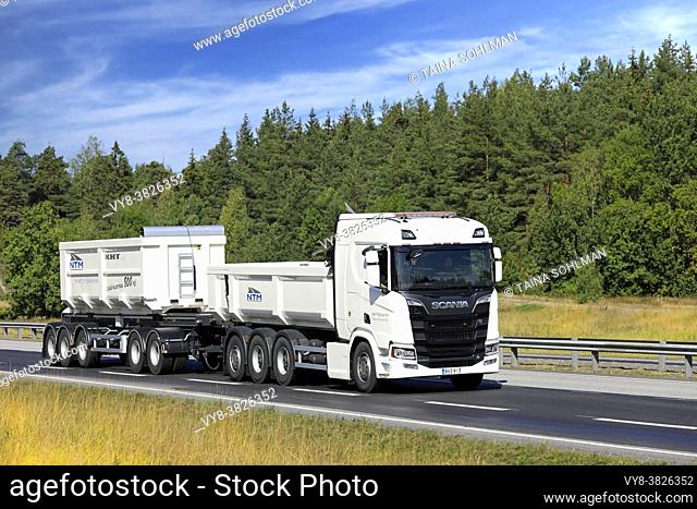 White Next Generation Scania R650 truck pulls gravel trailer on road test. Scania in Finland 70 years tour. Turku, Finland. August 24, 2019