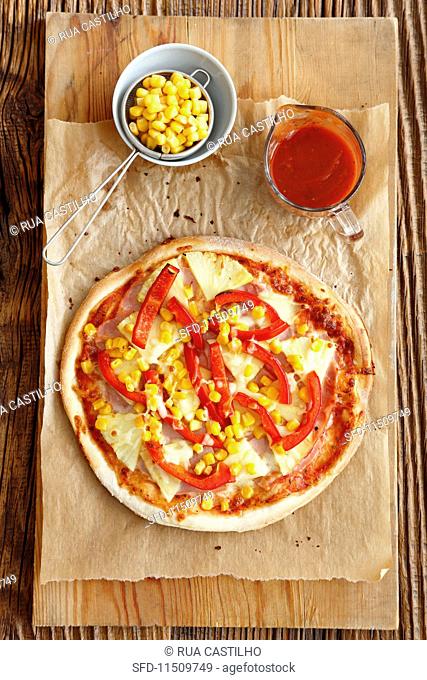 Pizza Hawaii with ham, pineapple, pepper and sweetcorn
