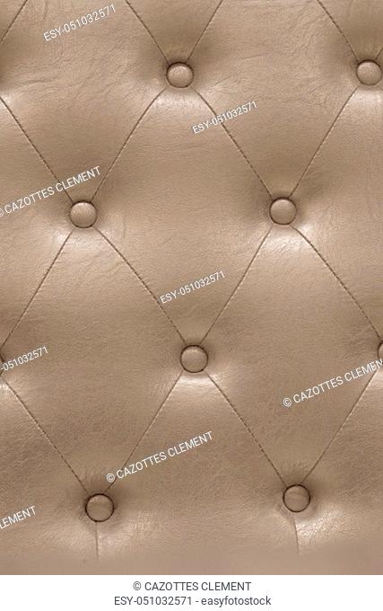 Highly detailed texture of golden beige vintage padded leather cloth