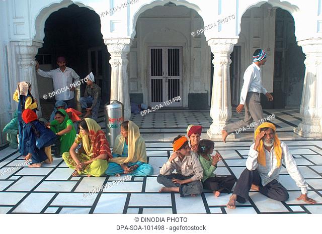Sikh praying at golden temple ; Amritsar ; Punjab ; India