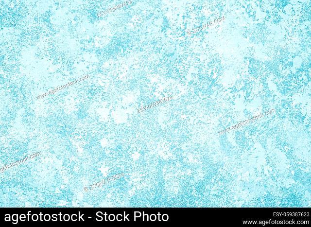 sponge painted light blue wall background with mottled paint texture pattern