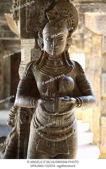 Carved figurines carrying lamps ; Carving on the pillars ; Near Nataksala (Hall of performance) ; solid granite pillars Padmanabhapuram Wood Palace ; Tamil Nadu...