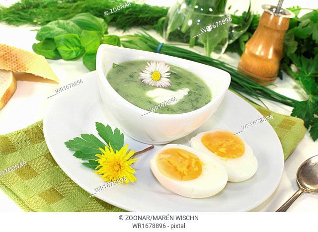 herbs soup with eggs, a dollop of cream