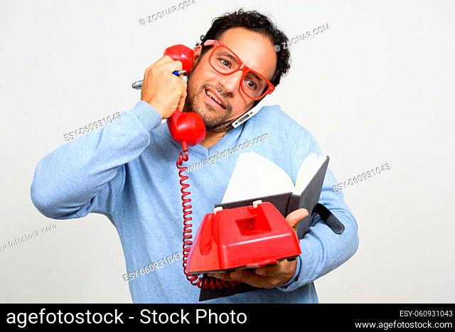 Studio shot of handsome bearded Hispanic man with curly hair against white background