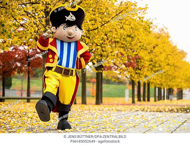 A mascot dressed as Capt'n Sharky walks through the autumnal exposition grounds in Rostock, Germany, 25 October 2016. The games
