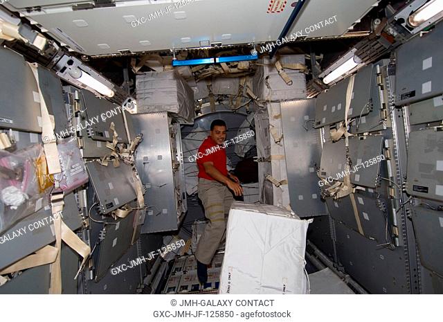 NASA astronaut Jose Hernandez, STS-128 mission specialist, works in the Leonardo Multi-Purpose Logistics Module (MPLM), temporarily attached to the...