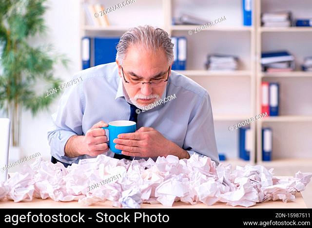 Old businessman rejecting ideas with lots of papers