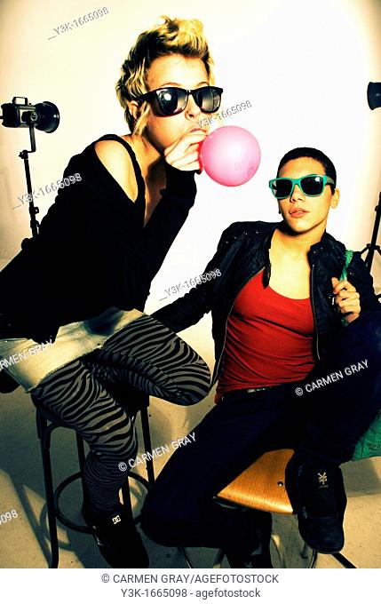 Studio picture of two girls playing with balloons