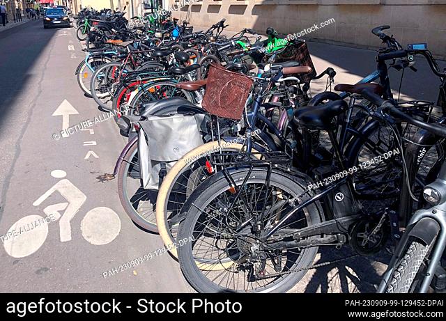 08 September 2023, France, Paris: Bicycles are parked at a parking space next to a bike lane. In the first three months of the year, bicycle use increased by 37