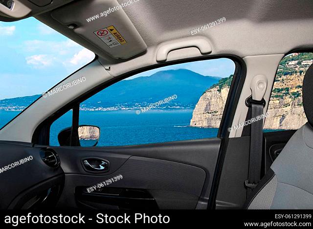 Looking through a car window with view of the iconic volcano Vesuvius from Sorrento Town in the Bay of Naples, Italy