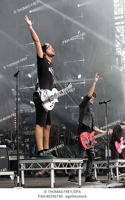 The singer of the US-band 'All Time Low ', Alex Gaskarth (R) and their guitarist, Jack Barakat, perform on stage during the 'Rock am Ring' festival in Nuerburg