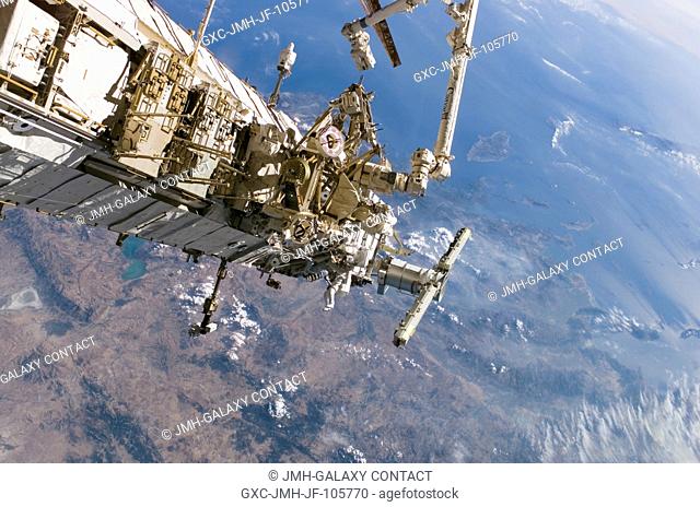 This panoramic scene of the International Space Station over terrain could be used for a quick game of find the two astronauts in this picture