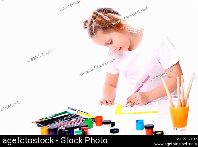 Girl drawing with brush and paint over white background