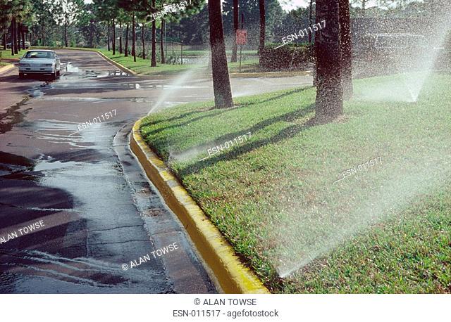 Excessive water use, irrigate grass on verges, Orlando, Florida, same in other cities, drought and water shortage, unnecessary waste of water