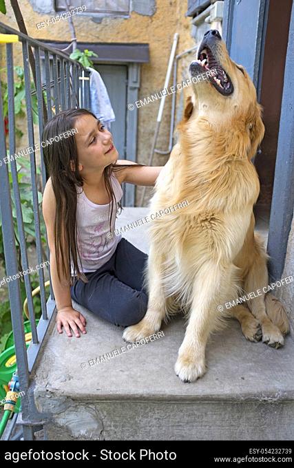 Little girl with her dog golden retriever