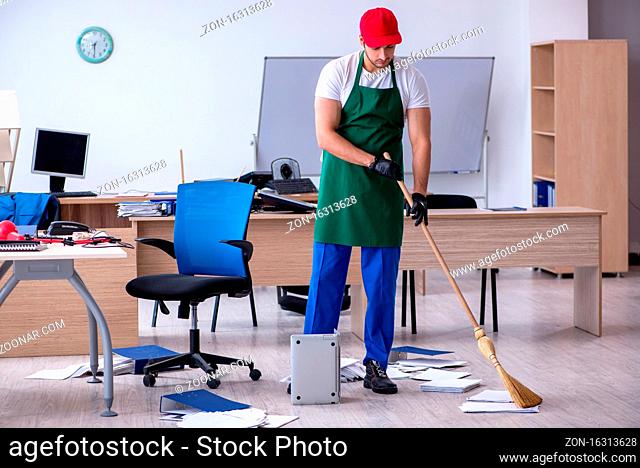 Young contractor cleaning the office