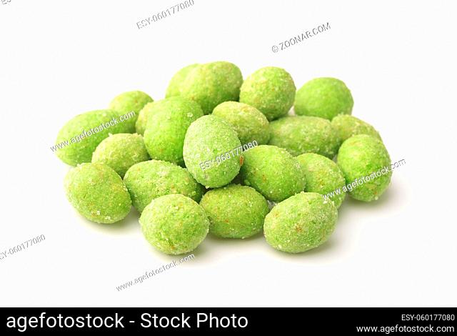 Heap of green wasabi coated peanuts isolated on white