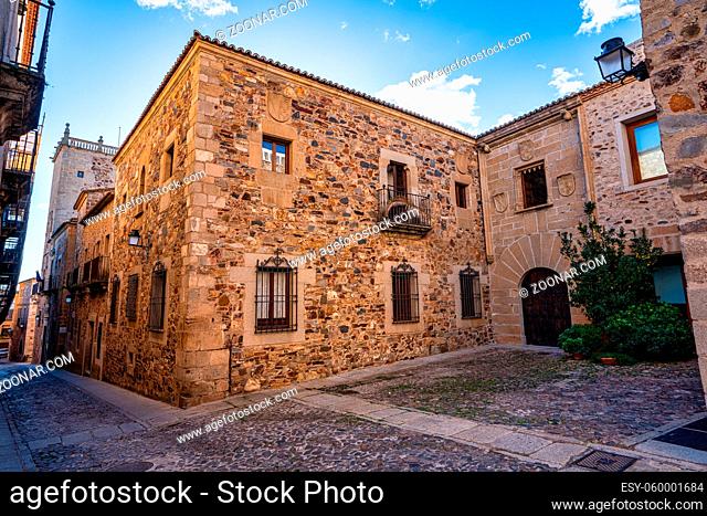 Narrow alley with old stone buildings at Caceres, Extremadura, Spain. A cute and charming town with a fully preserved medieval city center in western Spain