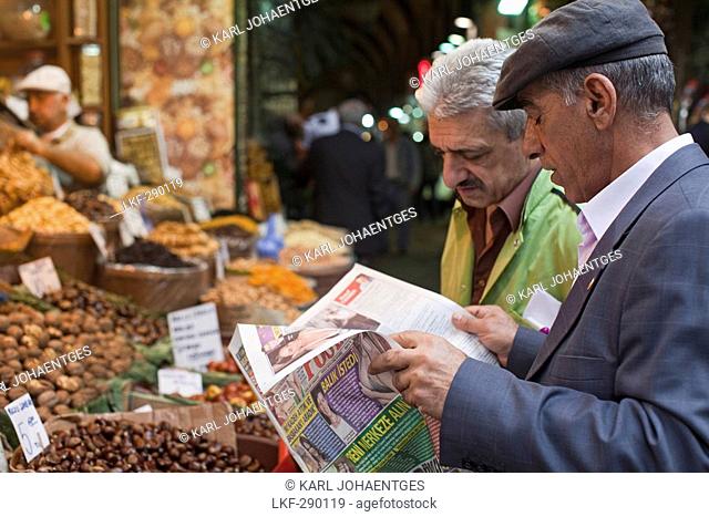 Turkish men with newspaper in Egyptian Bazaar, Istanbul, Turkey