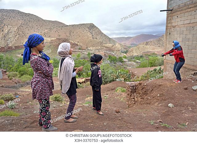 children playing in the compagny of a tourist in the village of Tighza, Ounila River valley, Ouarzazate Province, region of Draa-Tafilalet, Morocco