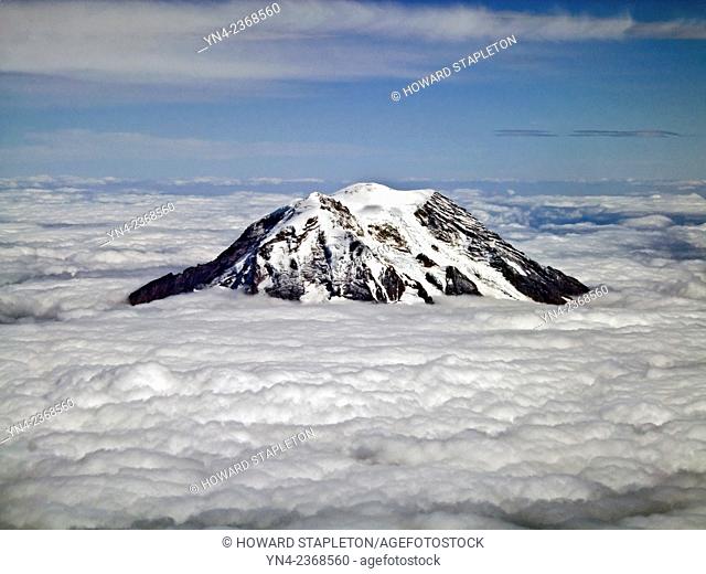 Mt. Rainier above the clouds. Rainier is the tallest mountain in th state of Washington about 55 miles southeast of Seattle. Mt