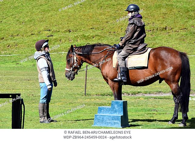 GLENORCHY, NZ - JAN 13:Horse riding instructor teaching a man to ride a Horse on Jan 13 2014.Approximately 200 people died from spinal injuries caused by...