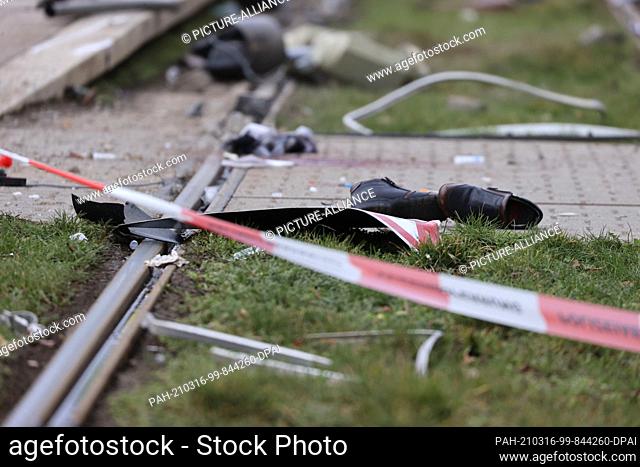 16 March 2021, Saxony, Leipzig: Shoes lie in a tram track bed behind a barrier tape at the scene of the accident. A car driver drove into a group of people in...