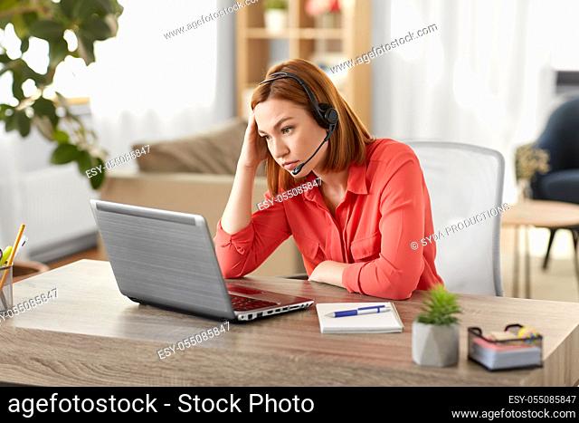 sad woman with headset and laptop working at home