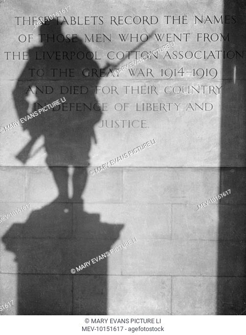 'The Shadow of Remembrance': A statue of a World War One soldier casts a shadow over a memorial tablet, Liverpool, England