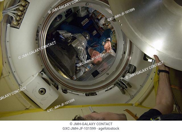 Russian cosmonaut Oleg Novitskiy, Expedition 33 flight engineer, waves as he prepares to ingress the International Space Station's Poisk Mini-Research Module 2...