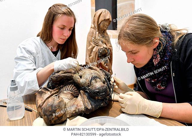 A medieval Pieta statue from Isserstedt is being preserved by Christin Bauerfeind (l-r) and Myra Lueers, students in the Master's program for restoration at the...