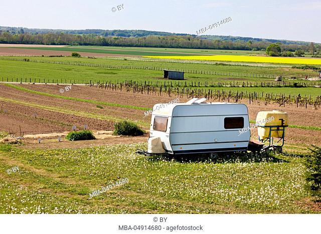 Old caravan on a field