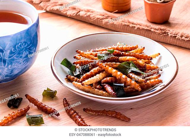 Fried insects - Bamboo worm insect crispy with pandan after fried and add a light coating of sauce and garnish Thai pepper powder, tea