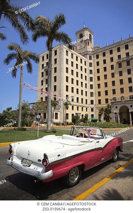 Vintage American car parked in front of Hotel Nacional in Vedado district, Havana, La Habana, Cuba, West Indies, Central America