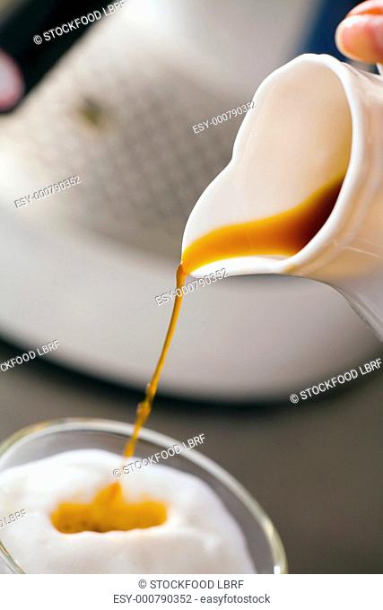 Making latte macchiato pouring espresso into glass