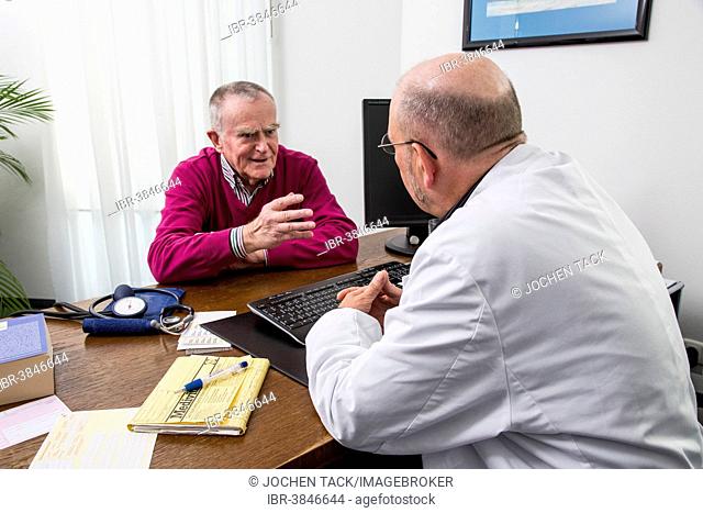 Medical practice, elderly patient talking to the doctor, Germany