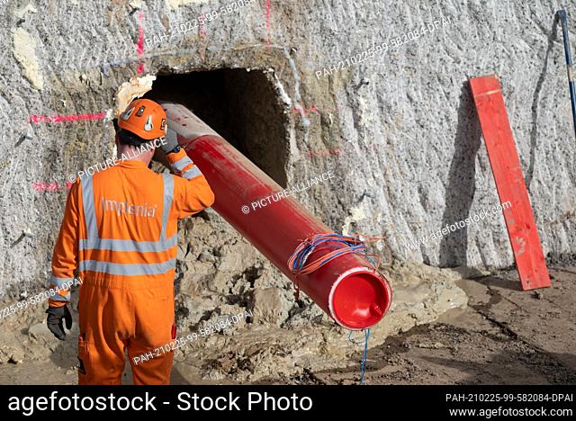 23 February 2021, Baden-Wuerttemberg, Leingarten: An empty pipe of the planned Suedlink electricity highway protrudes from a small tunnel in front of the...