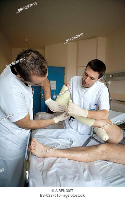 Photo essay from La Croix Saint-Simon Hospital, Paris, France. Department of orthopedics. Placement of a resin plaster by the physical therapists on a fractured...