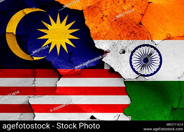 flags of Malaysia and India painted on cracked wall
