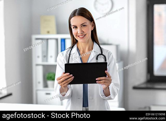 smiling female doctor with tablet pc at hospital