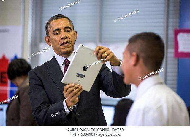 United States President Barack Obama prepares to use an iPad to record a seventh grader in a classroom that uses technology to enhance students' learning...