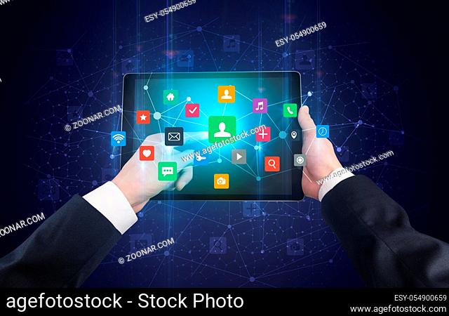 Hand using tablet with colorful bounce application symbols and icons concept