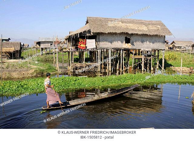 Intha leg rower in front of stilt houses in Mang-thawk, Inle Lake, Shan State, Myanmar, Burma, Southeast Asia