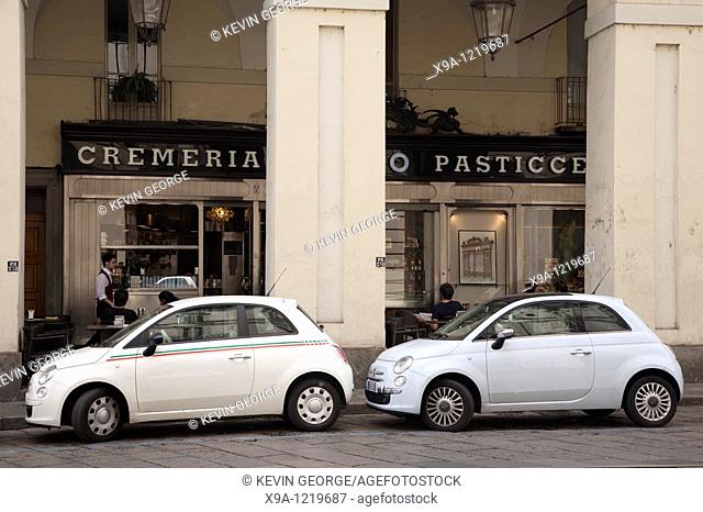 Cafe and two Fiat 500 Cars on Via Po Street in Turin, Italy