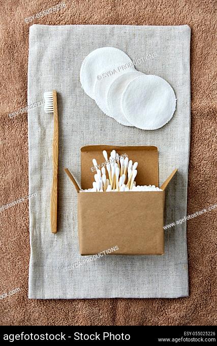 wooden toothbrush, cotton pads and swabs in box